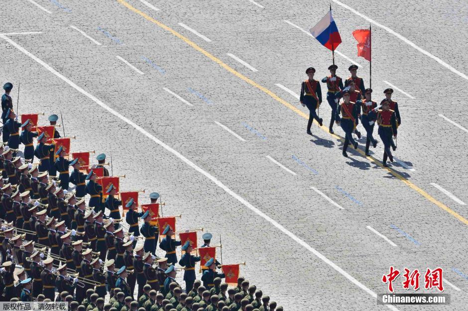 圖為俄羅斯國旗從受閱部隊(duì)前經(jīng)過。