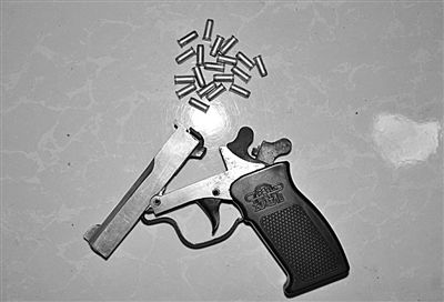 警方從搶劫嫌疑人處起獲的贓款和發(fā)令槍、子彈。警方供圖