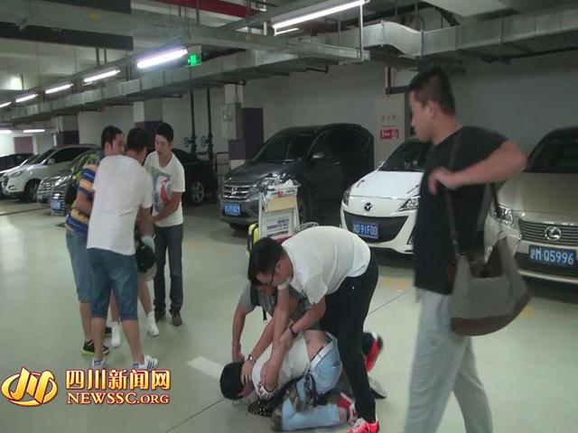 辦案人員在機(jī)場(chǎng)停車場(chǎng)抓獲胡某及其女友（警方視頻截圖）。