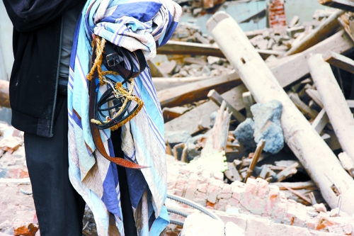 老人手中拿著曾控制住他的電線、床單