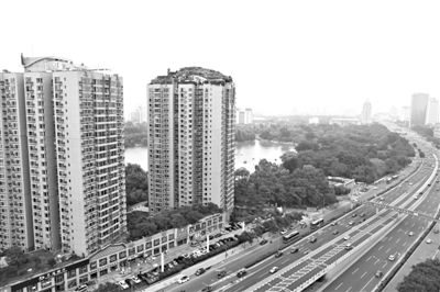 昨日，人濟(jì)山莊小區(qū)，與其他樓相比，B棟樓頂層天臺(tái)上違規(guī)建造了一棟兩層小樓，假山大樹俱全。新京報(bào)記者