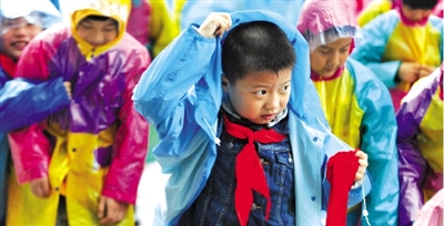 昨日下午,農(nóng)科路上一小學放學時,孩子們大部分都穿著雨披。