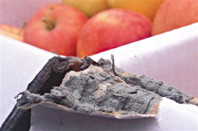 8月29日，新發(fā)地市場，一箱用“加重紙箱”包裝的蘋果正待售，紙箱夾層內(nèi)灰黑色的增重填充物清晰可見